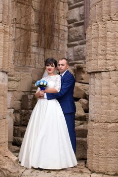 Bride and groom posing in the rain