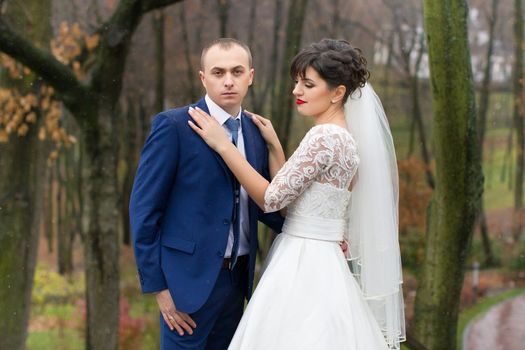 Bride and groom posing in the rain