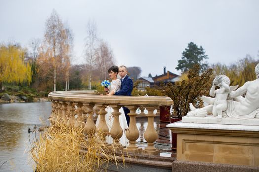 Bride and groom posing in the rain