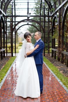 Couple standing in the rain on the wedding day