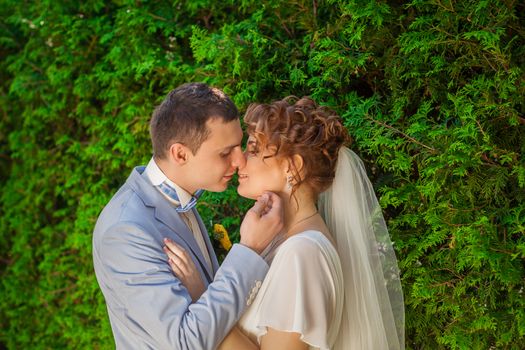 Romantic kiss happy bride and groom on wedding day