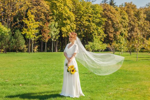 young happy girl with bouquet in daisy field