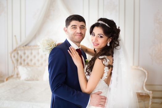 The groom gently hugged the bride on the wedding day