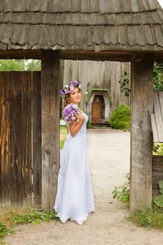 The bride with a bouquet of lilac with wreath
