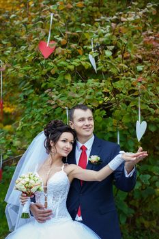 newly-married couple  on green grass in field