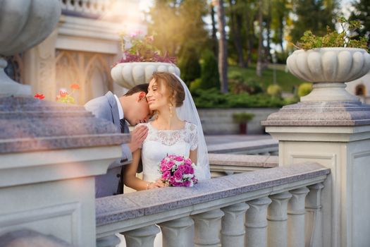 Bride and groom at wedding Day walking Outdoors on spring nature. Bridal couple, Happy Newlywed woman and man embracing in green park. Loving wedding couple outdoor. Bride and groom