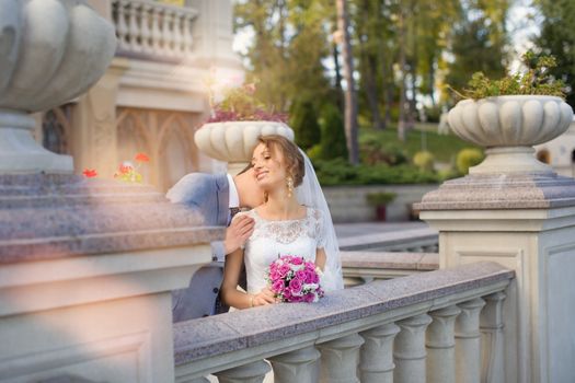 Bride and groom at wedding Day walking Outdoors on spring nature. Bridal couple, Happy Newlywed woman and man embracing in green park. Loving wedding couple outdoor. Bride and groom