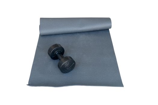 Dumbbell placed on a yoga mat with a white background.