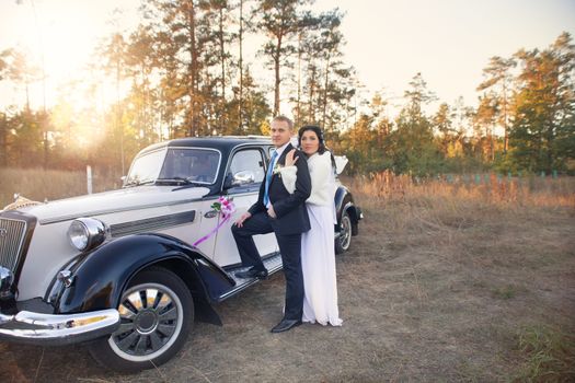 Young couple sitting  inside retro car