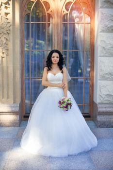 portrait of a brown-eyed sensual kinky girl in white dress on the window background, close up