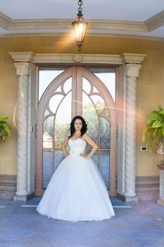 portrait of a brown-eyed sensual kinky girl in white dress on the window background, close up