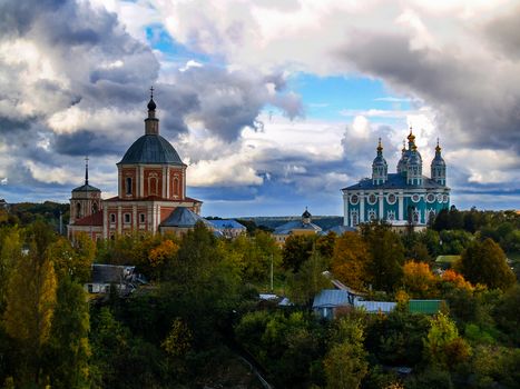 Urban autumn landscape and views of the temples in autumn day with clouds in the sky