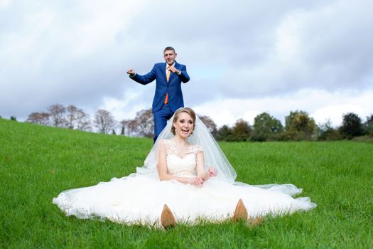 Newlyweds walks away outdoors. Railroad in the forest