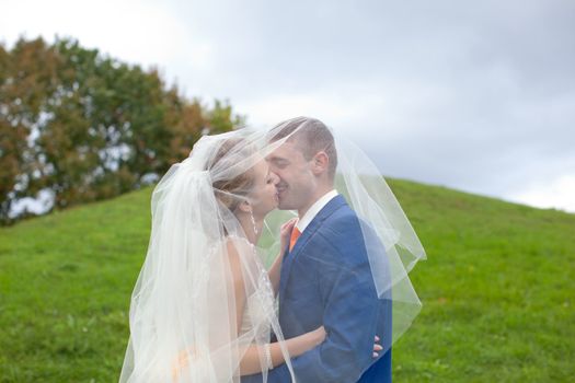 Newlyweds walks away outdoors. Railroad in the forest