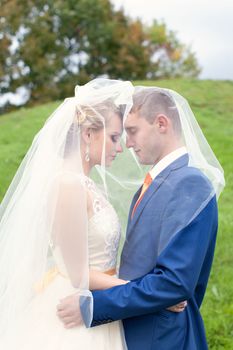 Newlyweds walks away outdoors. Railroad in the forest