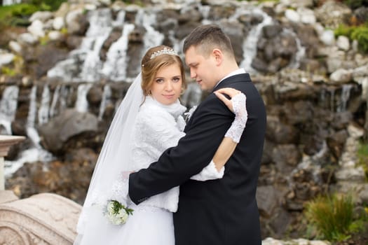 happy beautiful bride and groom walking on field. Loving wedding couple outdoor. Bride and groom.Wedding concept.