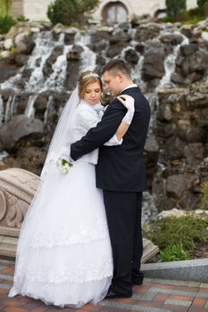 happy beautiful bride and groom walking on field. Loving wedding couple outdoor. Bride and groom.Wedding concept.