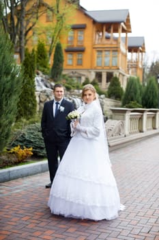 happy beautiful bride and groom walking on field. Loving wedding couple outdoor. Bride and groom.Wedding concept.