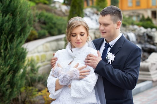 happy beautiful bride and groom walking on field. Loving wedding couple outdoor. Bride and groom.Wedding concept.