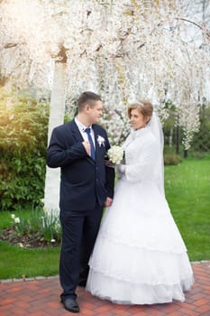 happy beautiful bride and groom walking on field. Loving wedding couple outdoor. Bride and groom.Wedding concept.