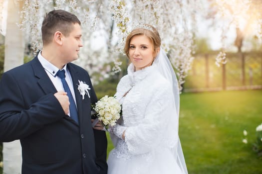 happy beautiful bride and groom walking on field. Loving wedding couple outdoor. Bride and groom.Wedding concept.