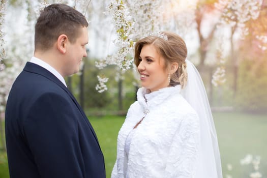 happy beautiful bride and groom walking on field. Loving wedding couple outdoor. Bride and groom.Wedding concept.