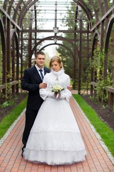 happy beautiful bride and groom walking on field. Loving wedding couple outdoor. Bride and groom.Wedding concept.