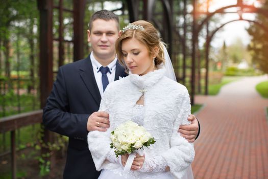 happy beautiful bride and groom walking on field. Loving wedding couple outdoor. Bride and groom.Wedding concept.