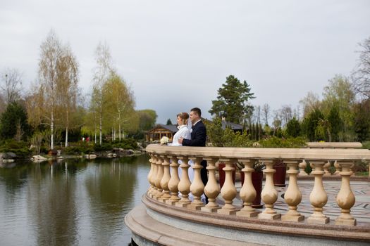 happy beautiful bride and groom walking on field. Loving wedding couple outdoor. Bride and groom.Wedding concept.