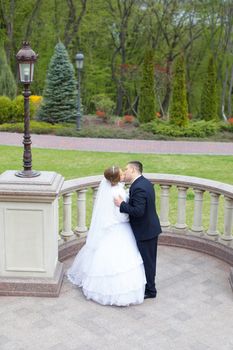 happy beautiful bride and groom walking on field. Loving wedding couple outdoor. Bride and groom.Wedding concept.