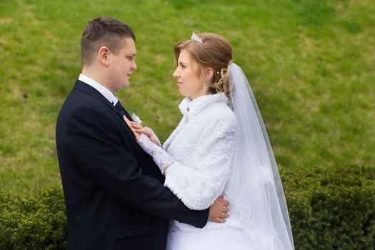 happy beautiful bride and groom walking on field. Loving wedding couple outdoor. Bride and groom.Wedding concept.