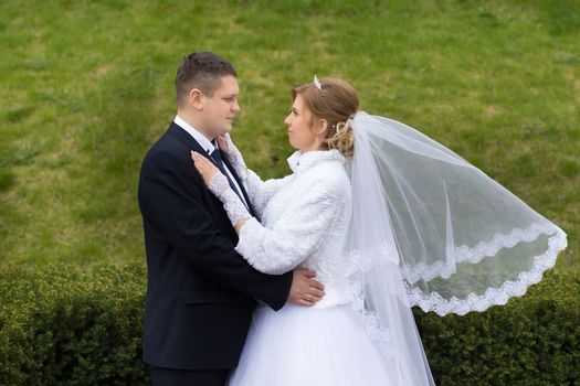 happy beautiful bride and groom walking on field. Loving wedding couple outdoor. Bride and groom.Wedding concept.