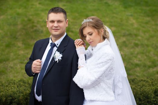 happy beautiful bride and groom walking on field. Loving wedding couple outdoor. Bride and groom.Wedding concept.