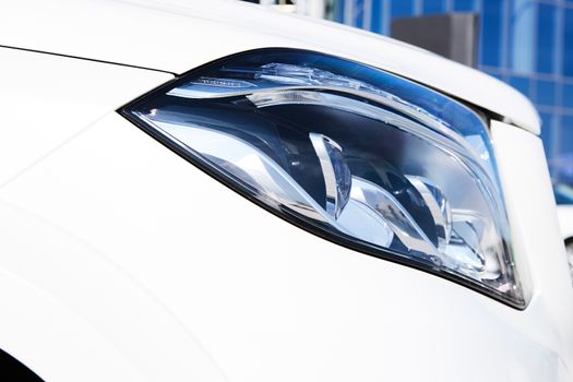 Closeup headlights of luxury car. Car exterior detail.