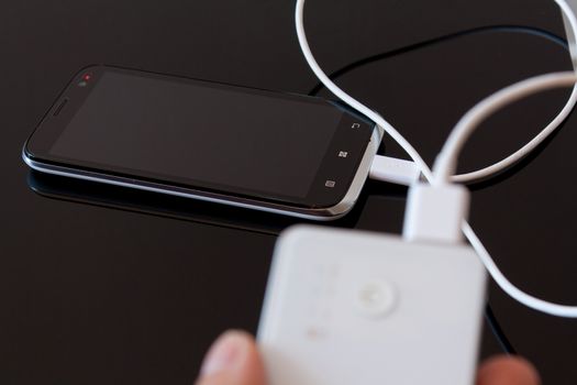 Smartphone is charging with power bank while it standby