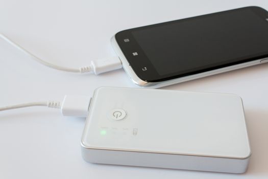 Smartphone is charging with power bank while it standby