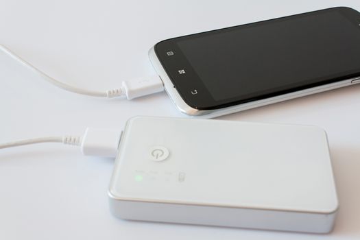 Smartphone is charging with power bank while it standby