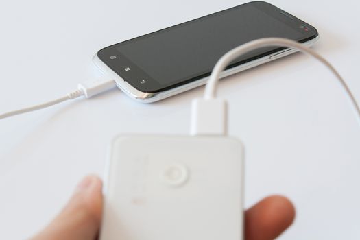 Smartphone is charging with power bank while it standby