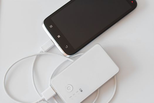 Smartphone is charging with power bank while it standby