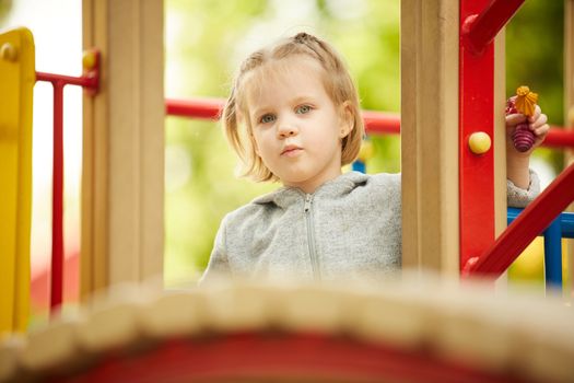 A girl playing at the playground in the park