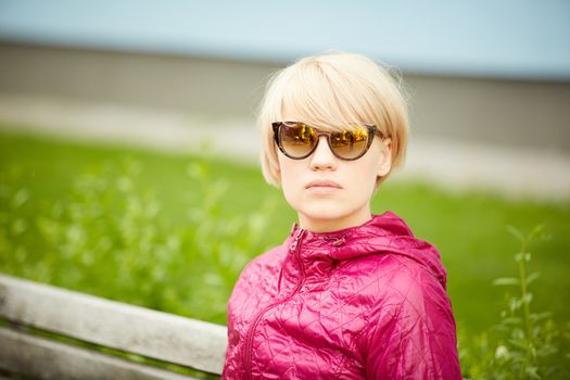 Young woman with short blond hair in sunglasses