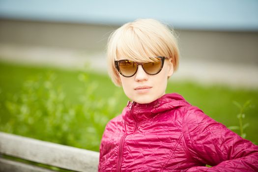 Young woman with short blond hair in sunglasses