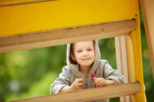 A girl playing at the playground in the park