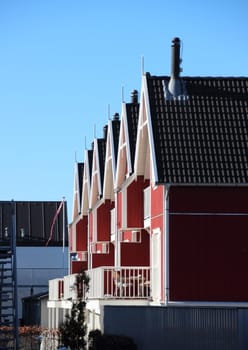 Apartment houses in red wood with blue sky