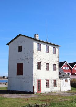 Isolated abandoned three storage building near new houses