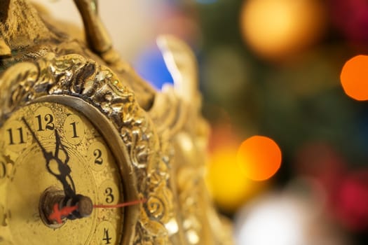 Happy New Year, clock before midnight on a Christmas tree background