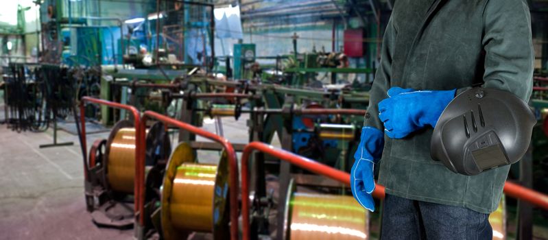 Worker welder with instruments at industrial factory