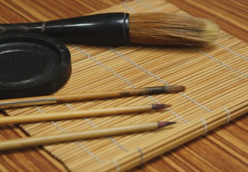 Chinese writing brush and ink stone on Keep brush mat.