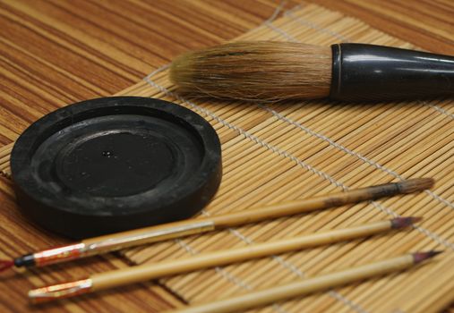 Chinese writing brush and ink stone on Keep brush mat.