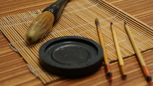 Chinese writing brush and ink stone on  keep brush mat.